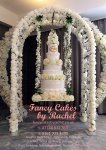 floral arch with swing wedding cake